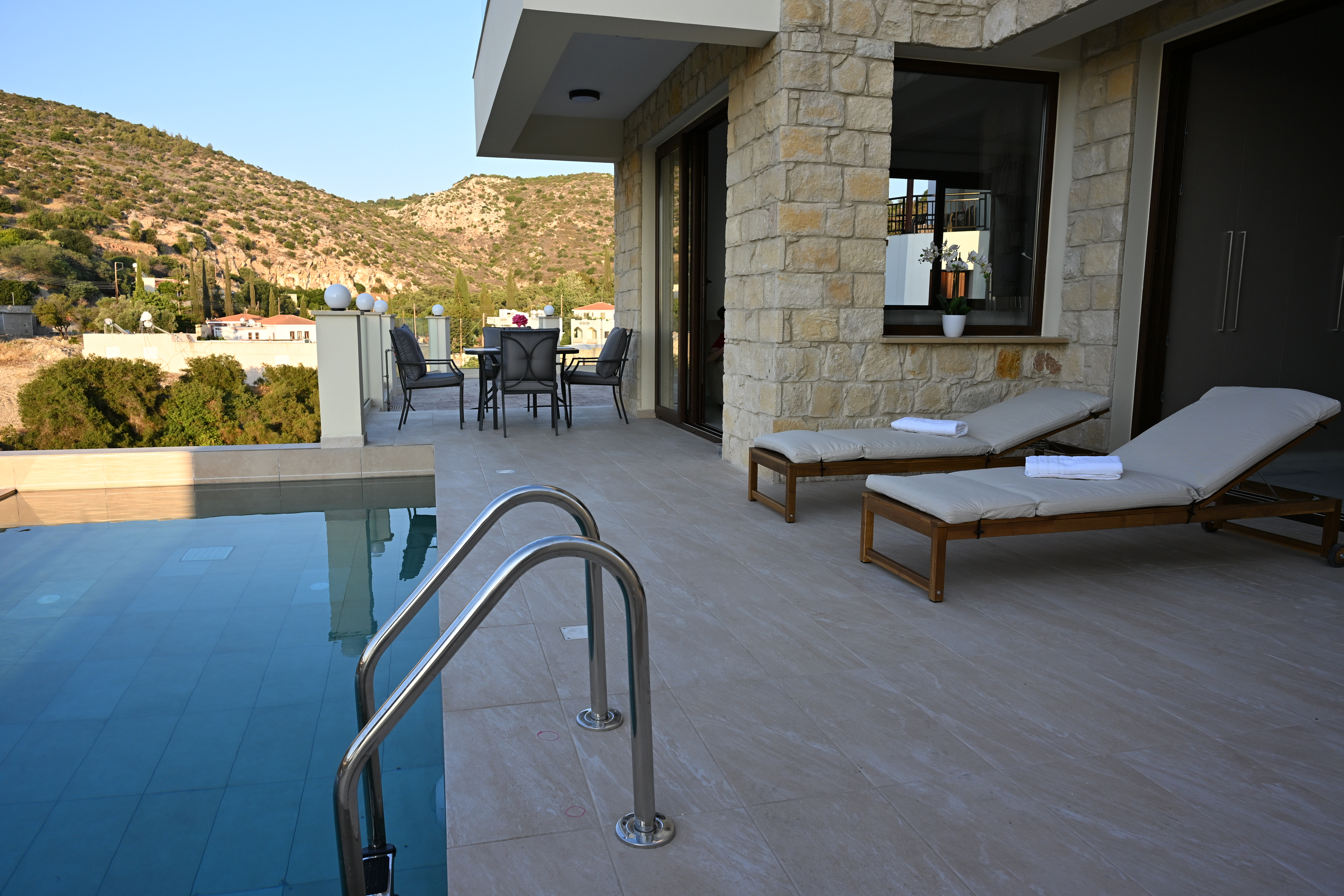The Queen's pool and two comfortable sunbeds beside it