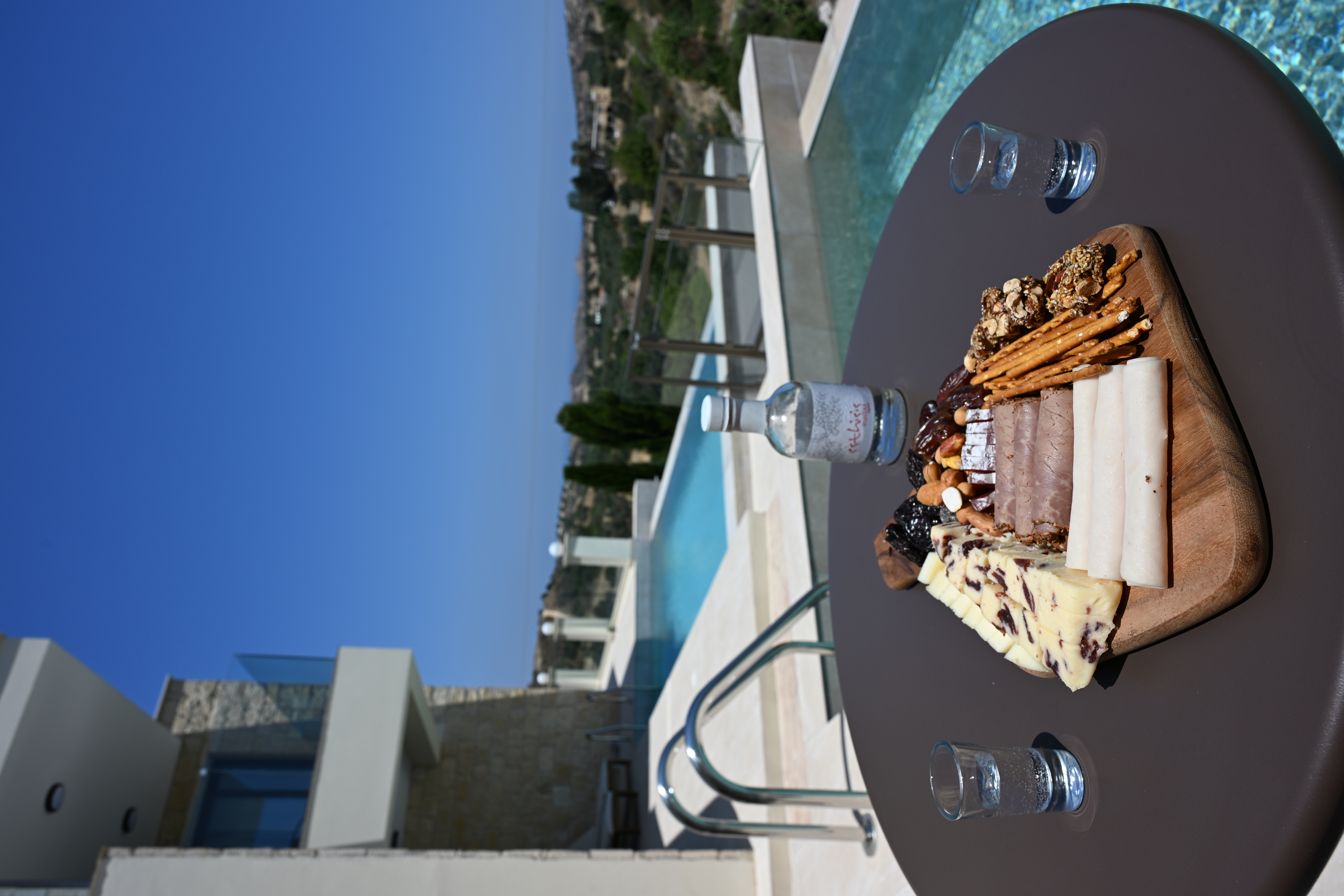 A view of The Royal Houses pools along with a charcuterie board on a table