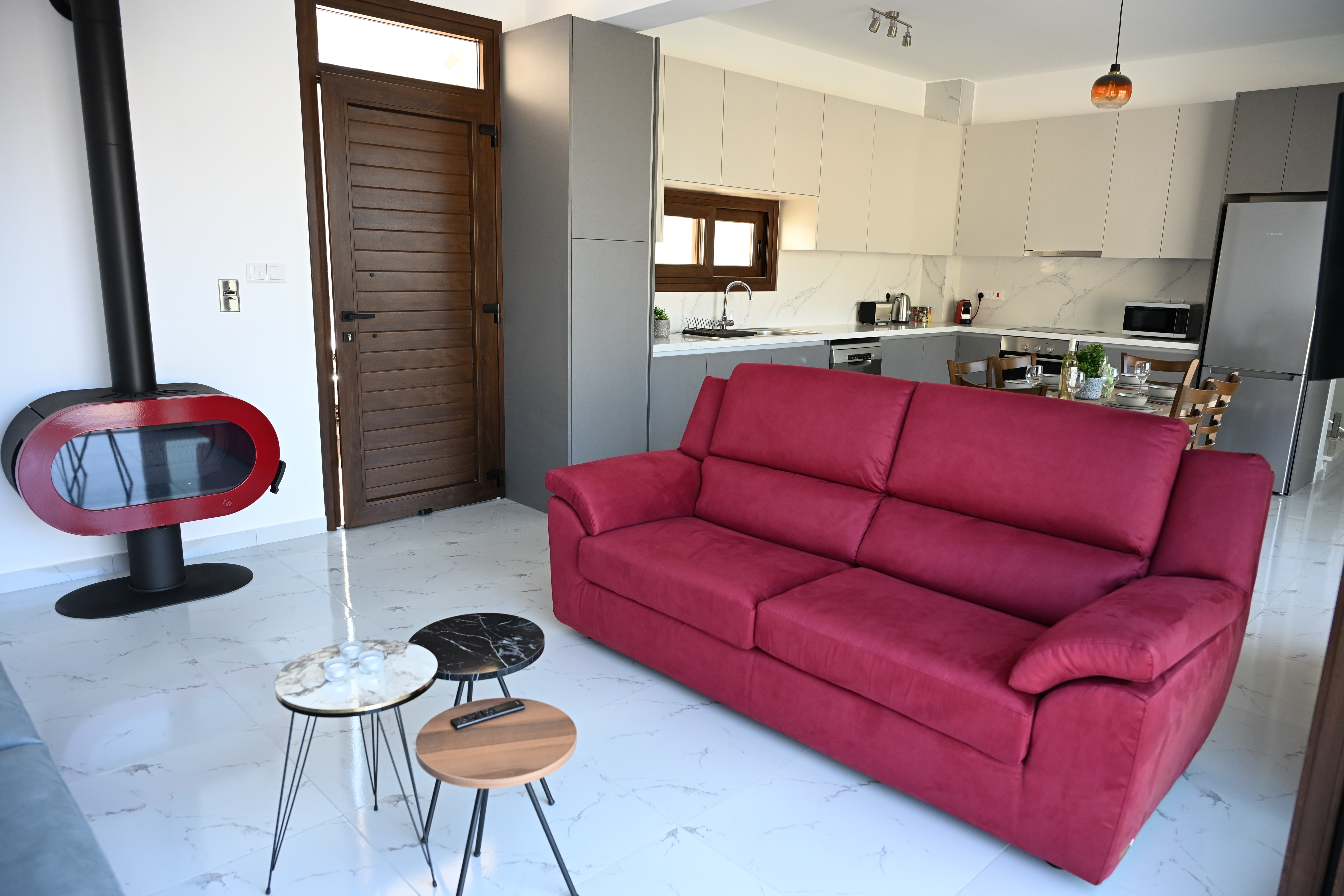 The Prince's living room with a red fireplace and a signature red couch