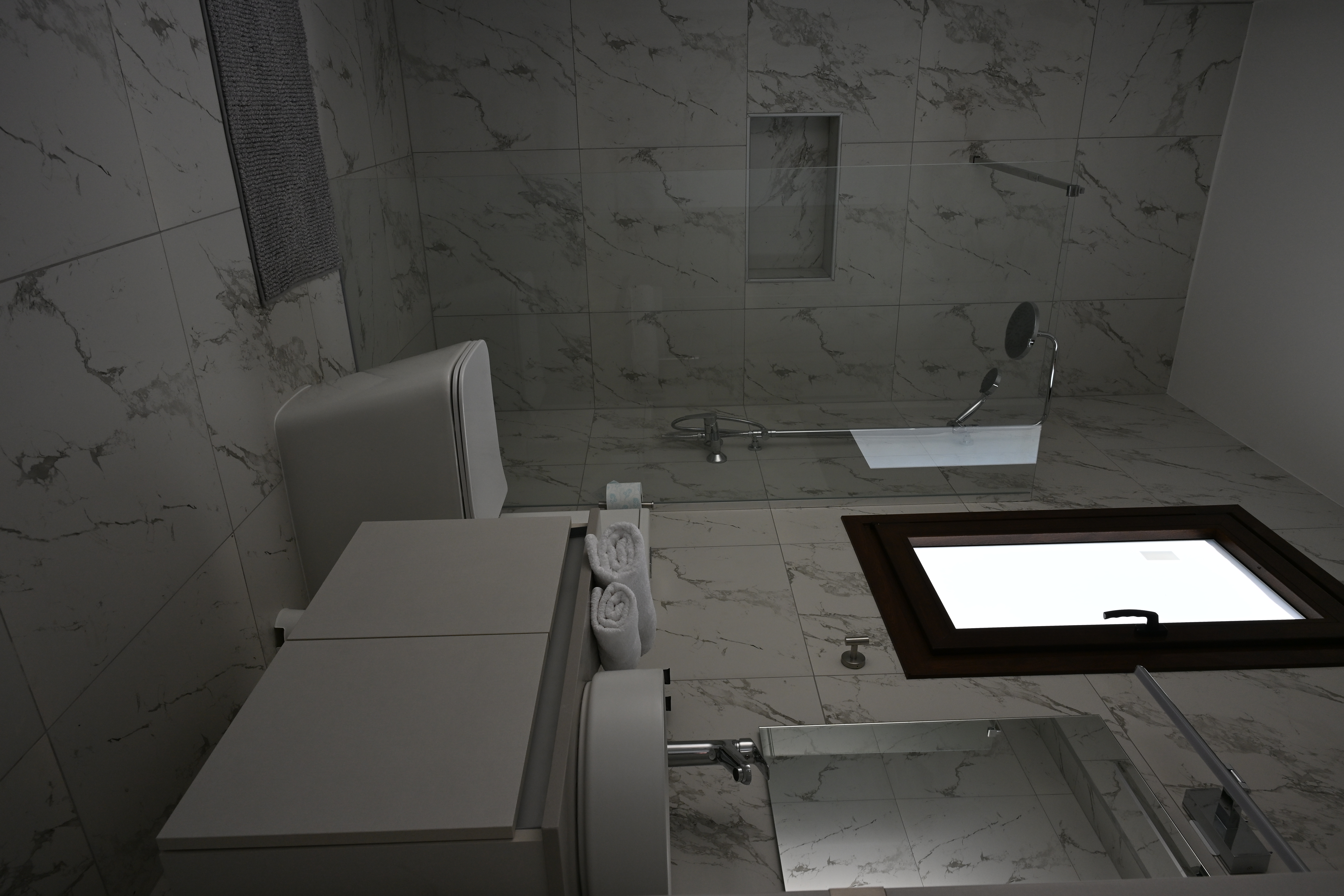 An extended view of the bathroom with the shower